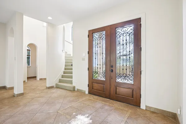 a kitchen with stainless steel appliances granite countertop a stove top oven a sink and a refrigerator