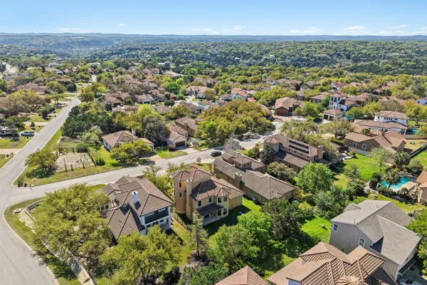 an aerial view of a house with a yard