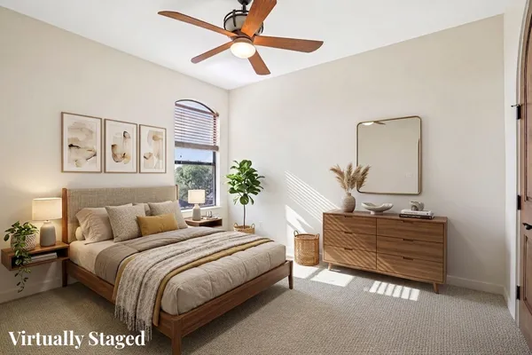 a bedroom with a bed dresser and a window