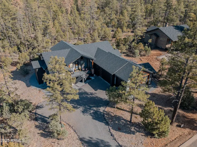 a view of a house with a yard covered with snow