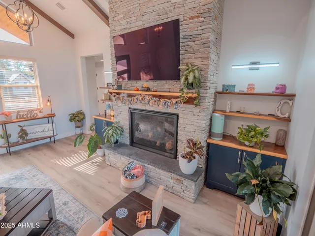 a spacious bedroom with a large bed and a potted plant