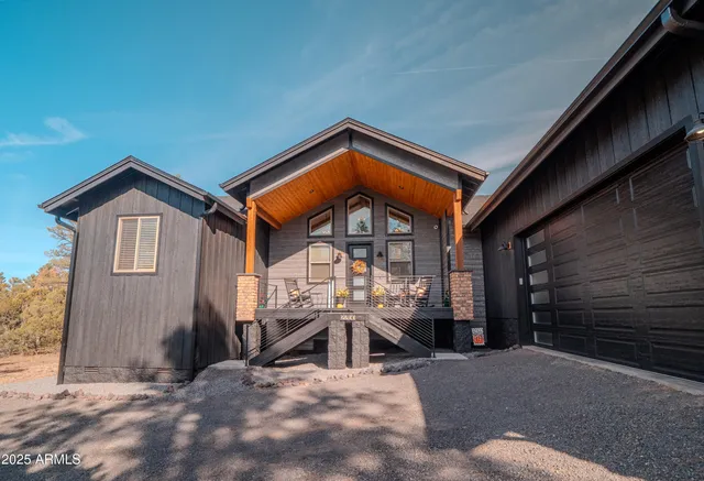 a view of a patio with table and chairs with wooden floor and fence