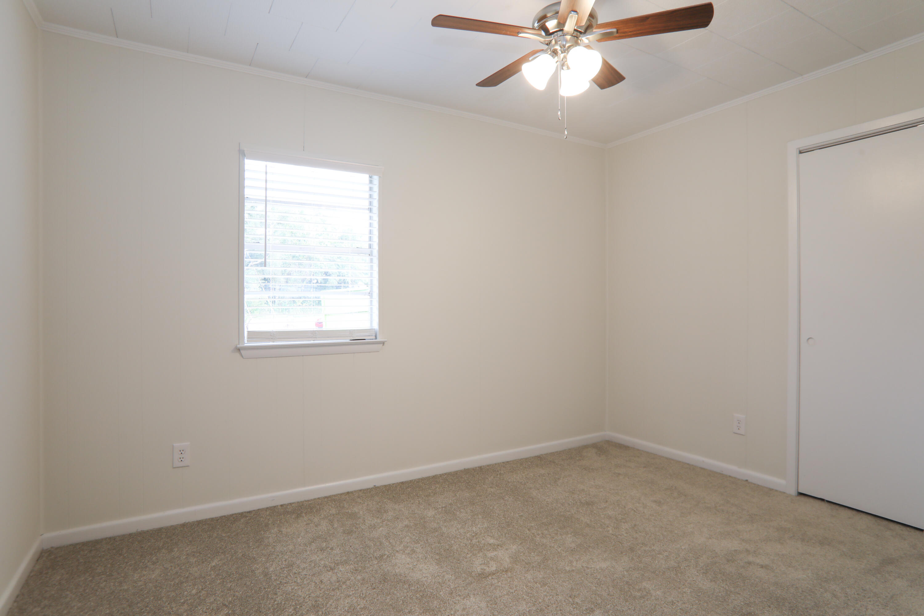16 Pond Creek Road Crestview, FL 32539 - Photo 11 of 20 an empty room with a window and a fan