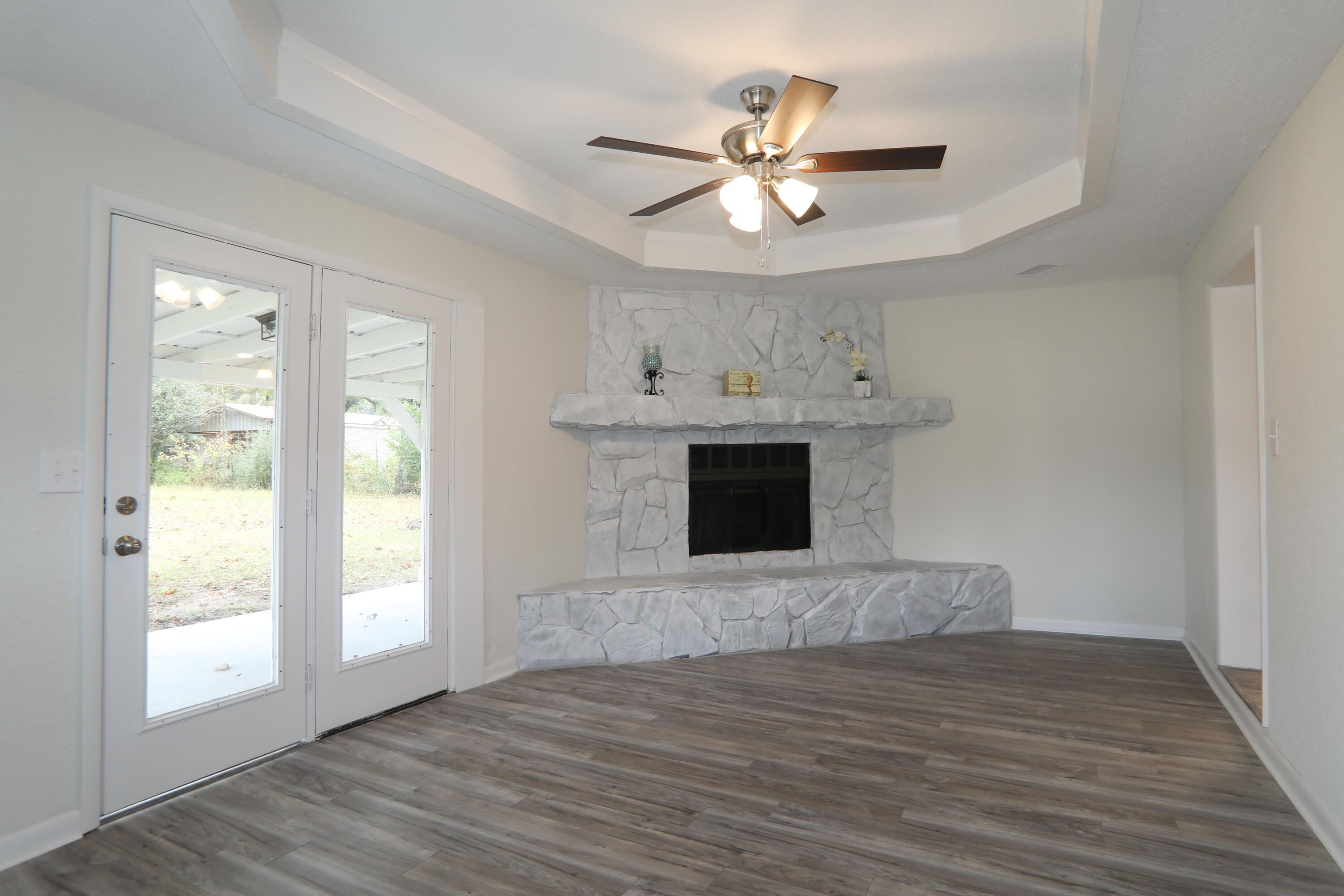 16 Pond Creek Road Crestview, FL 32539 - Photo 6 of 20 a view of a livingroom with a fireplace a ceiling fan and wooden floor