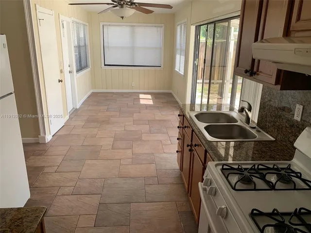 a kitchen that has a sink and a stove