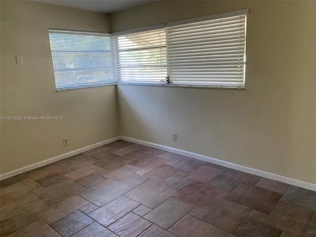 a view of empty room with floor to ceiling window