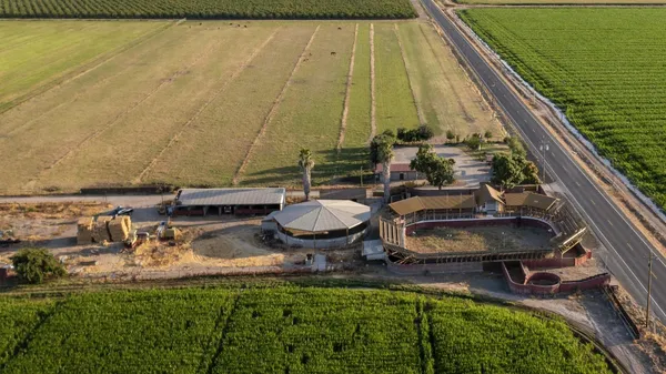 a aerial view of a house with swimming pool and outdoor seating