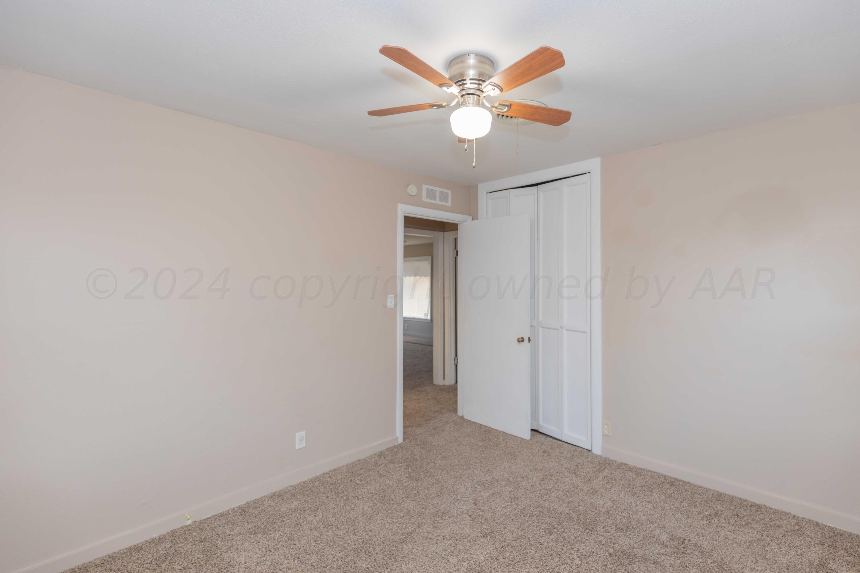 4318 South Monroe Street Amarillo, TX 79110 - Photo 25 of 36 an empty room with a window and a ceiling fan