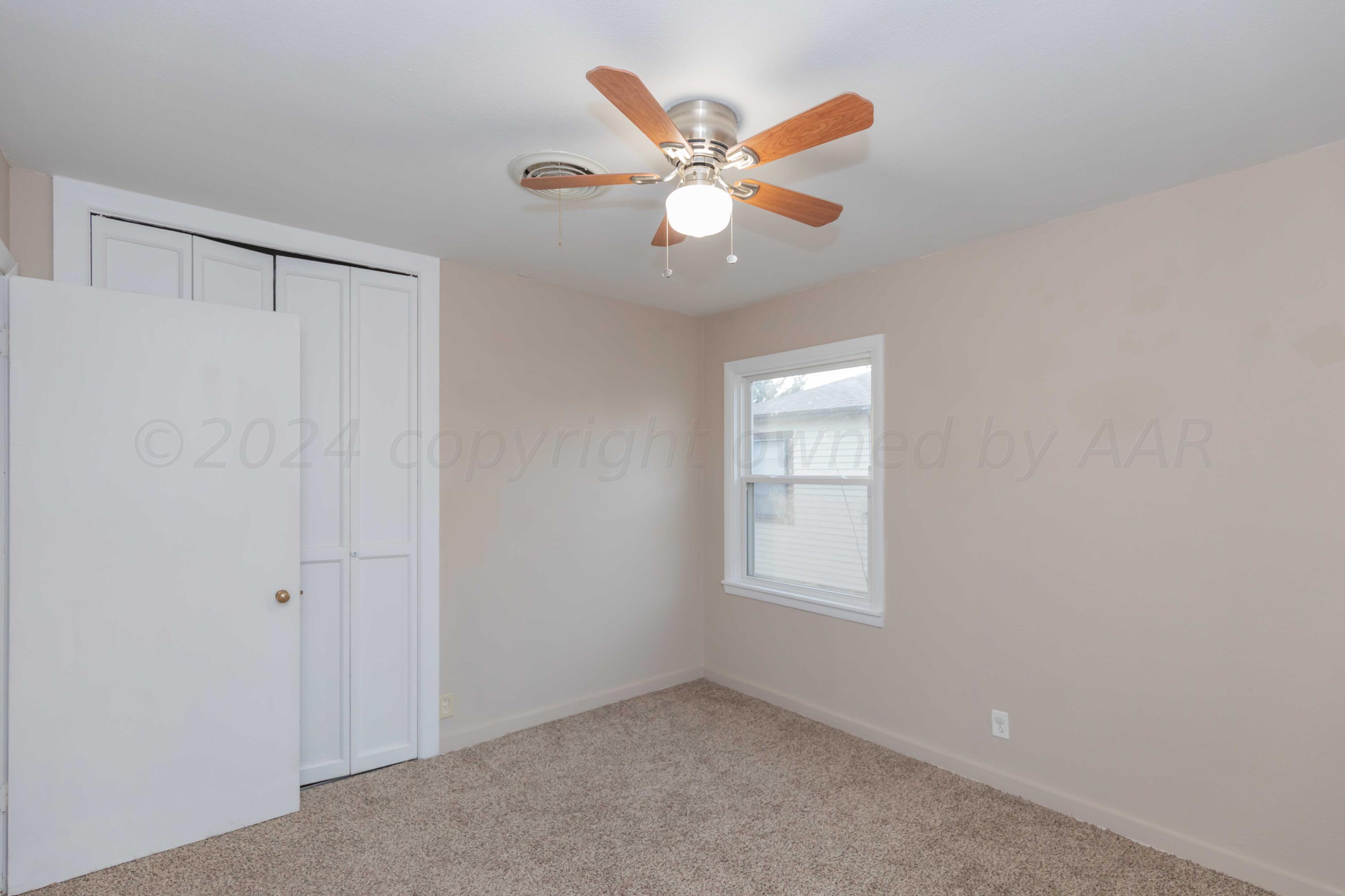 4318 South Monroe Street Amarillo, TX 79110 - Photo 26 of 36 an empty room with window and ceiling fan