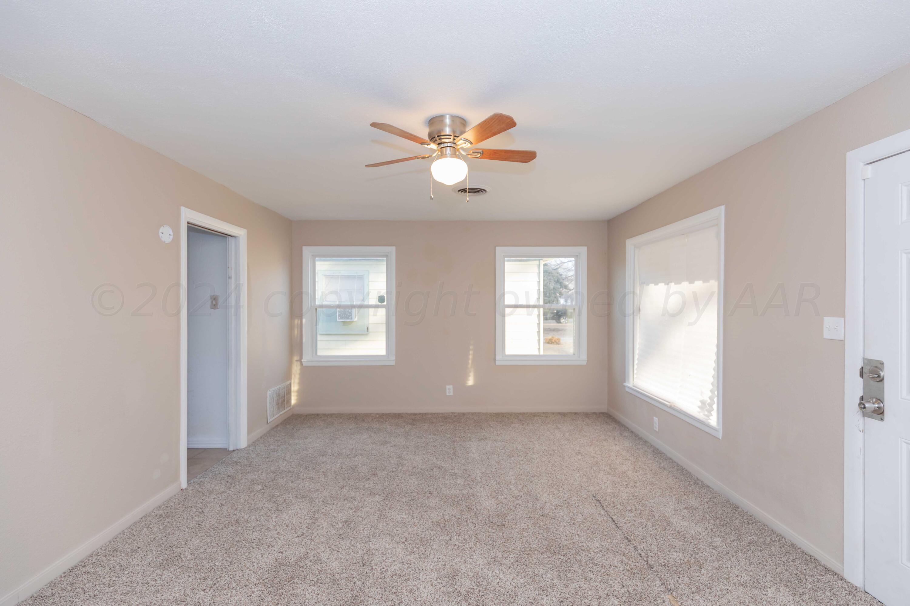 4318 South Monroe Street Amarillo, TX 79110 - Photo 4 of 36 a view of room with a ceiling fan and window