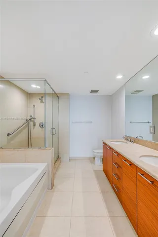 a bathroom with a tub sink and a mirror
