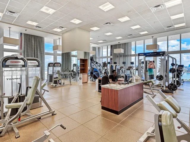 a living room with lots of furniture and kitchen view