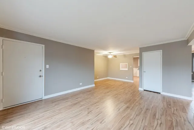 a view of an empty room with wooden floor
