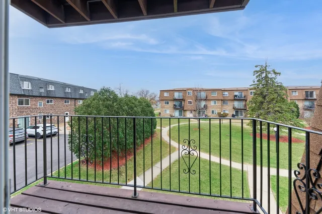 a view of a balcony with lake view and wooden floor