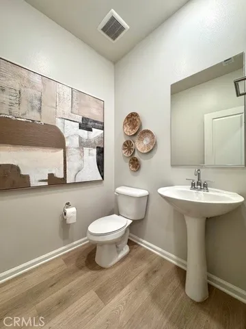 a bathroom with a sink toilet and mirror