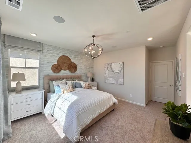 a bedroom with bed and a window