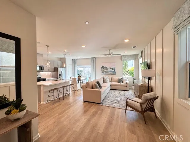 a living room with furniture a wooden floor and a sink