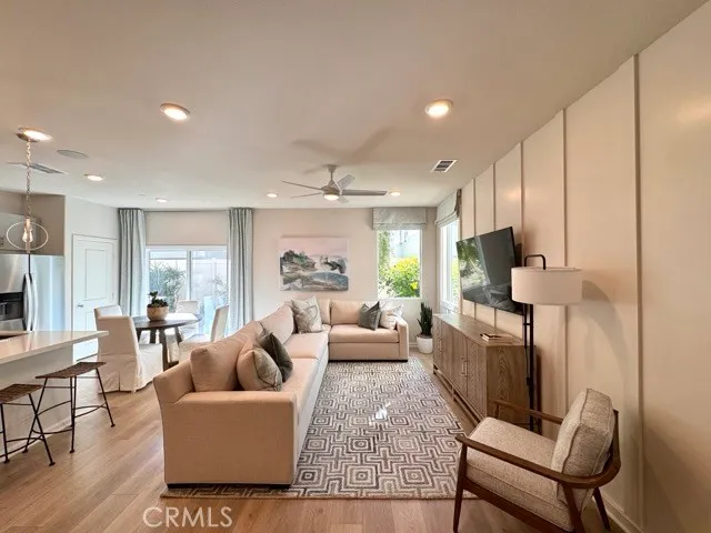 a living room with fireplace furniture and a wooden floor