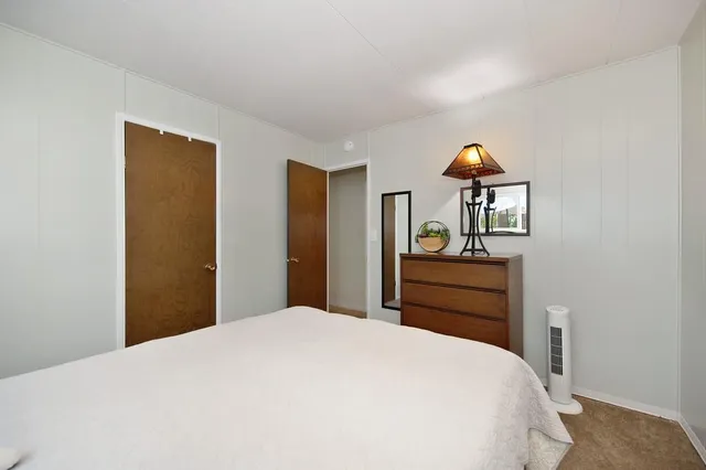 a bedroom with a bed and a dresser