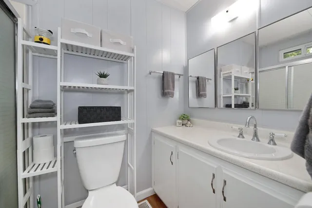 a bathroom with a toilet sink and mirror