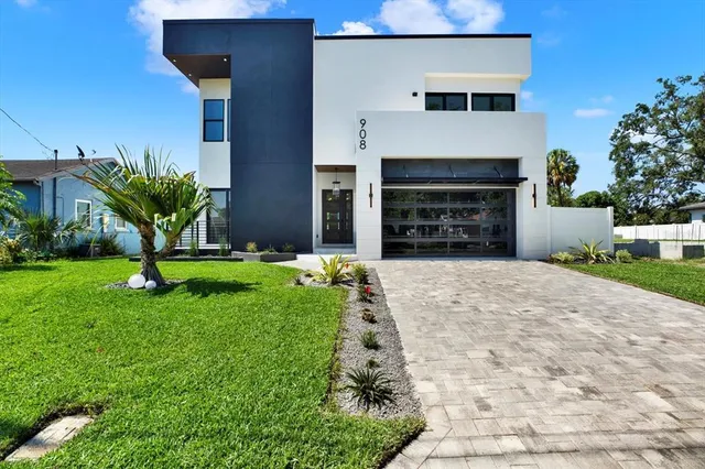 a front view of a house with a yard and a garage