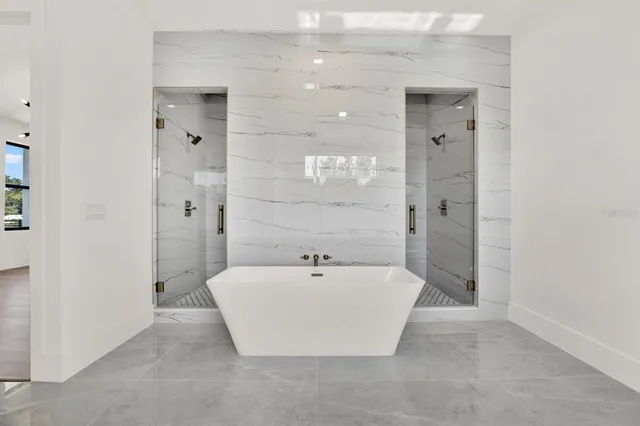 a bathroom with a bathtub and shower