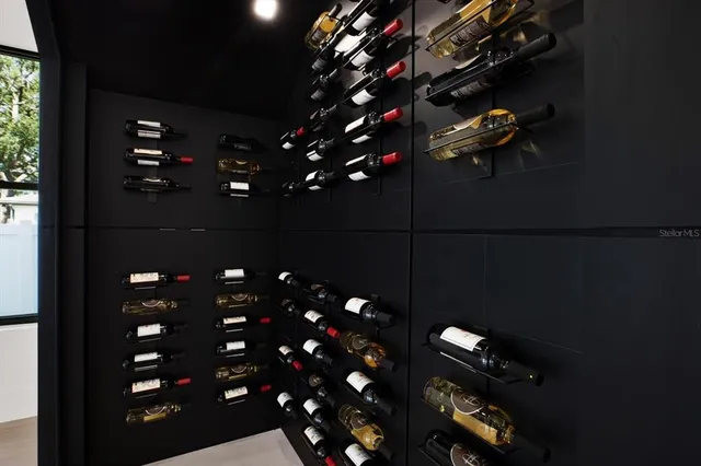 a view of a porch with a floor to ceiling window and potted plants
