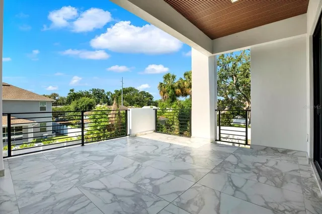 a view of a white house with a swimming pool