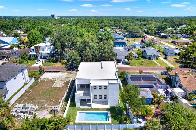 an aerial view of a houses with a yard