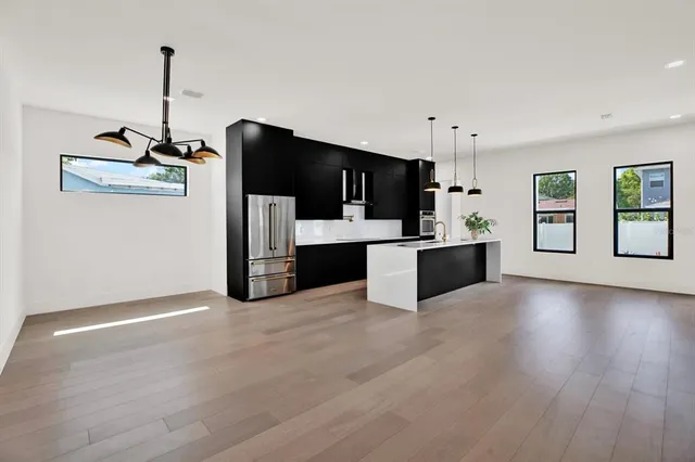 a living room with stainless steel appliances kitchen island granite countertop furniture and a view of kitchen