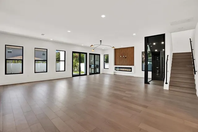 a view of a lobby with entryway wooden floor and windows