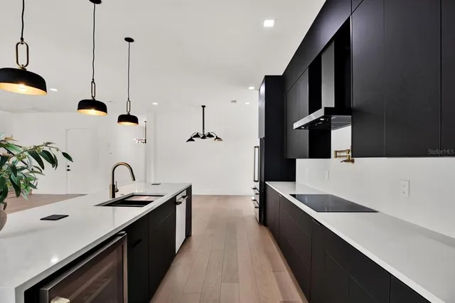 a kitchen with a sink and a refrigerator