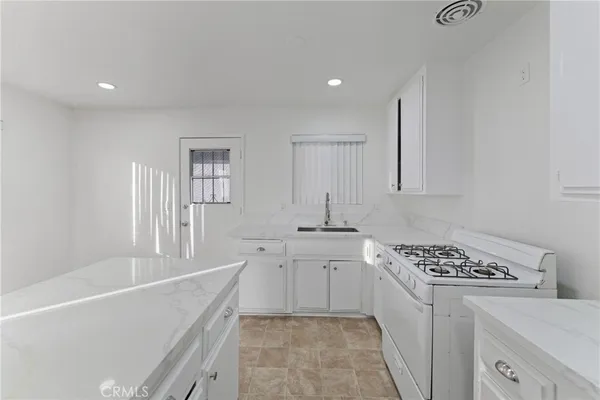 a kitchen with a stove and cabinets
