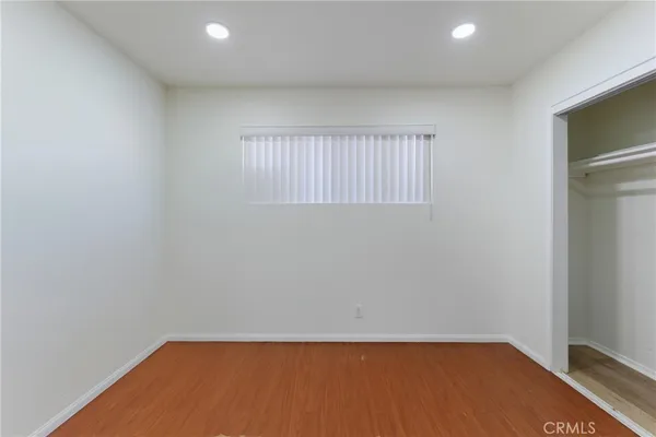 a house that has a couple of table and chairs in front of it