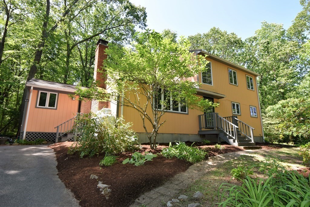 20 Amherst Road Hopkinton, MA 01748 - Photo 1 of 27 a front view of a house with a yard and tree s