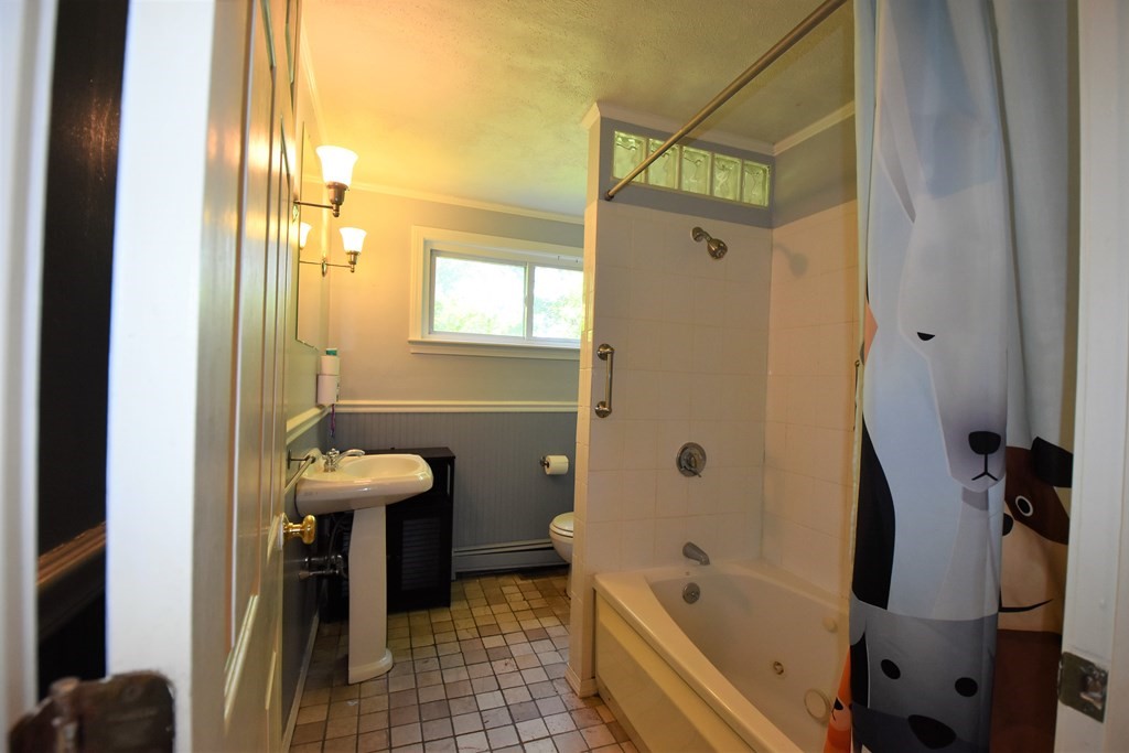 20 Amherst Road Hopkinton, MA 01748 - Photo 12 of 27 a bathroom with a tub a sink and glass door