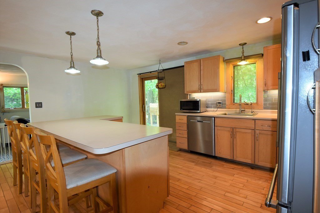 20 Amherst Road Hopkinton, MA 01748 - Photo 3 of 27 a kitchen that has a sink a stove and a wooden floor