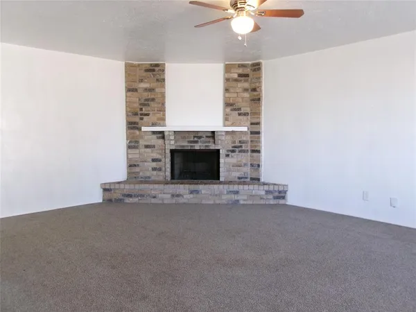an empty room with a fireplace