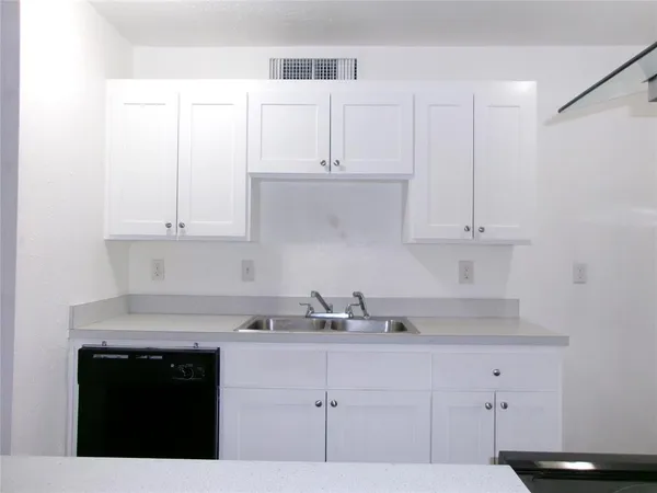 a kitchen with white cabinets