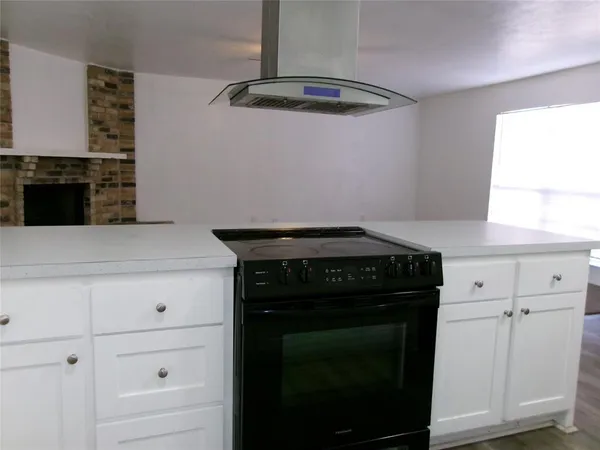 a kitchen with a stove and a cabinet