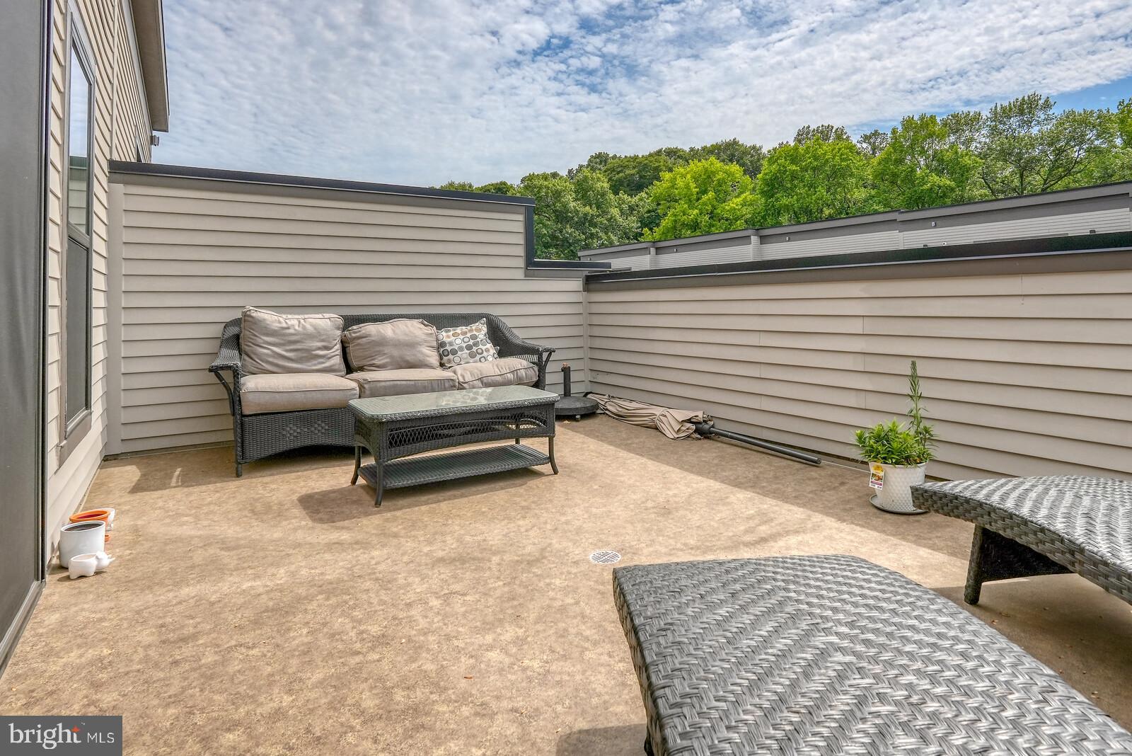 5345 Zenith Overlook Bethesda, MD 20816 - Photo 50 of 53 a view of a patio with a table and chairs and potted plants