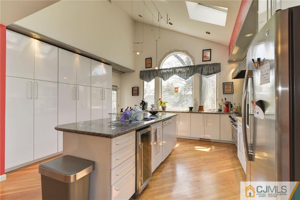77 Rolling Hills Road Clifton, NJ 07013 - Photo 1 of 16 a kitchen with stainless steel appliances granite countertop a sink and a refrigerator