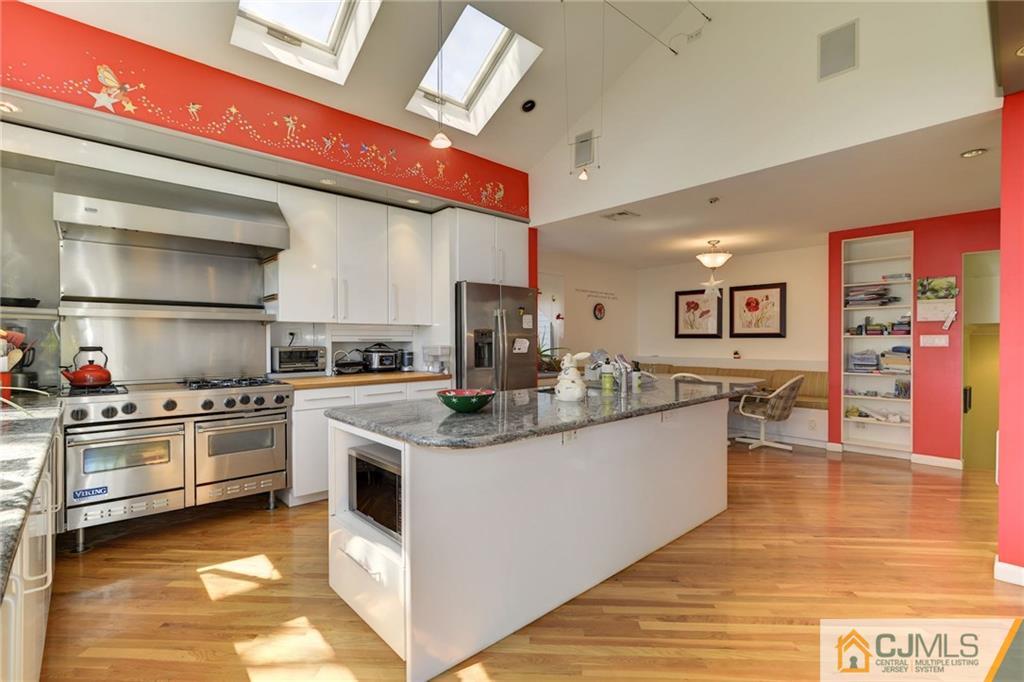 77 Rolling Hills Road Clifton, NJ 07013 - Photo 2 of 16 a kitchen with stainless steel appliances granite countertop a stove and a sink