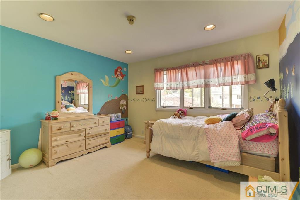 77 Rolling Hills Road Clifton, NJ 07013 - Photo 13 of 16 a living room with baby bed furniture and a window