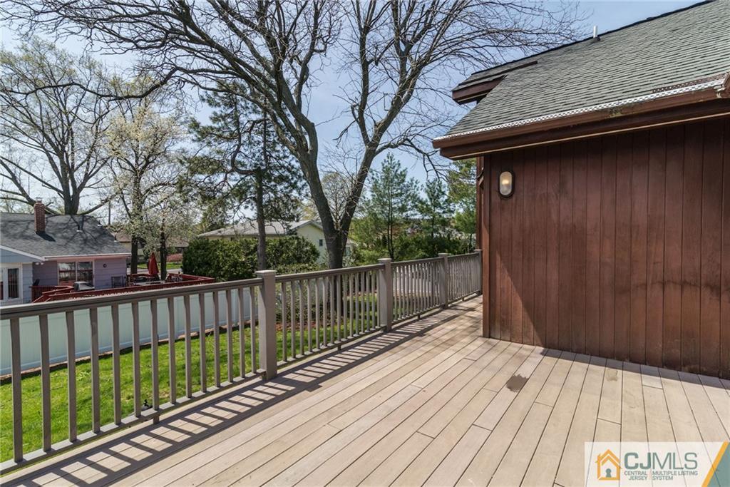 77 Rolling Hills Road Clifton, NJ 07013 - Photo 15 of 16 a balcony with wooden floor in front of it