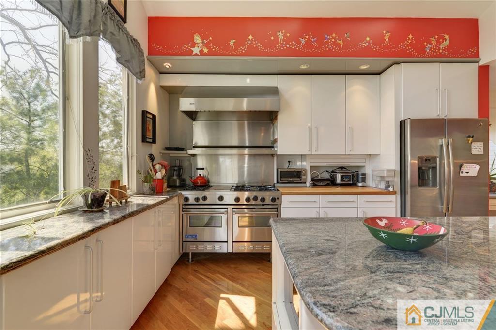 77 Rolling Hills Road Clifton, NJ 07013 - Photo 3 of 16 a kitchen with a stove a sink and a refrigerator