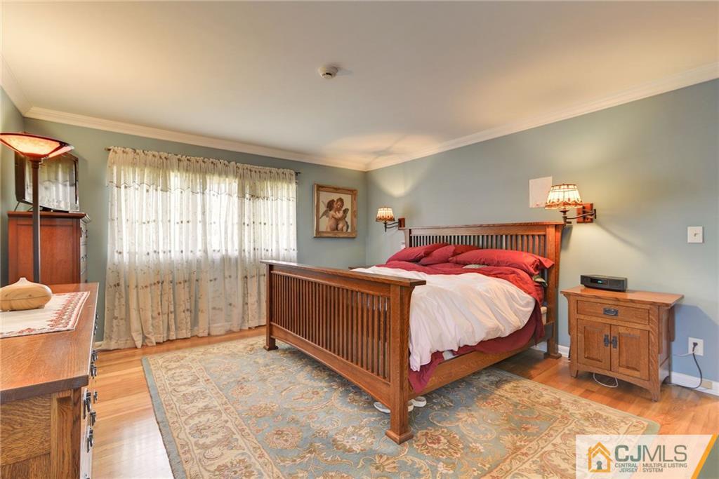 77 Rolling Hills Road Clifton, NJ 07013 - Photo 9 of 16 a spacious bedroom with a bed and a window