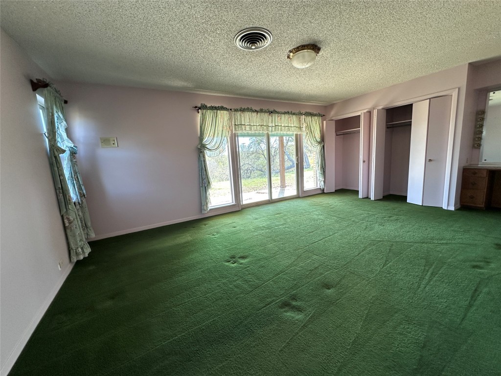 180 Griesenbeck Ranch Road Bastrop, TX 78602 - Photo 13 of 19 a view of an empty room with window and stairs