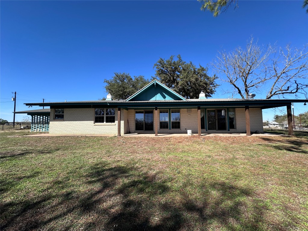 180 Griesenbeck Ranch Road Bastrop, TX 78602 - Photo 18 of 19 a front view of a house with a yard and garage