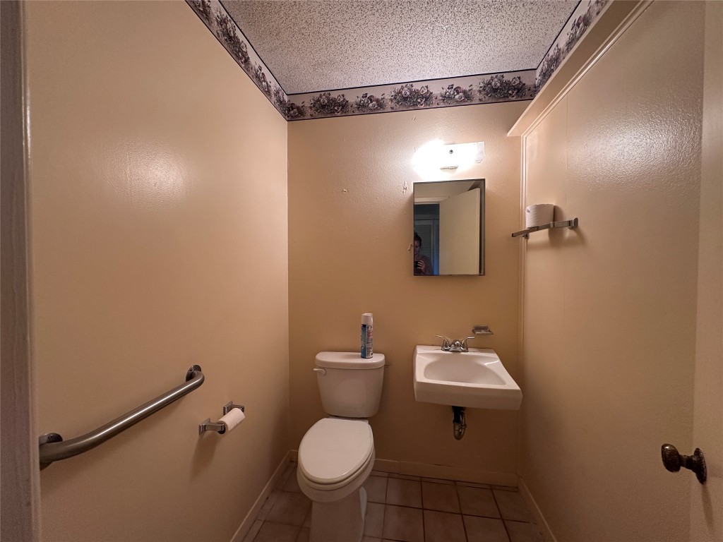 180 Griesenbeck Ranch Road Bastrop, TX 78602 - Photo 4 of 19 a bathroom with a toilet sink and mirror